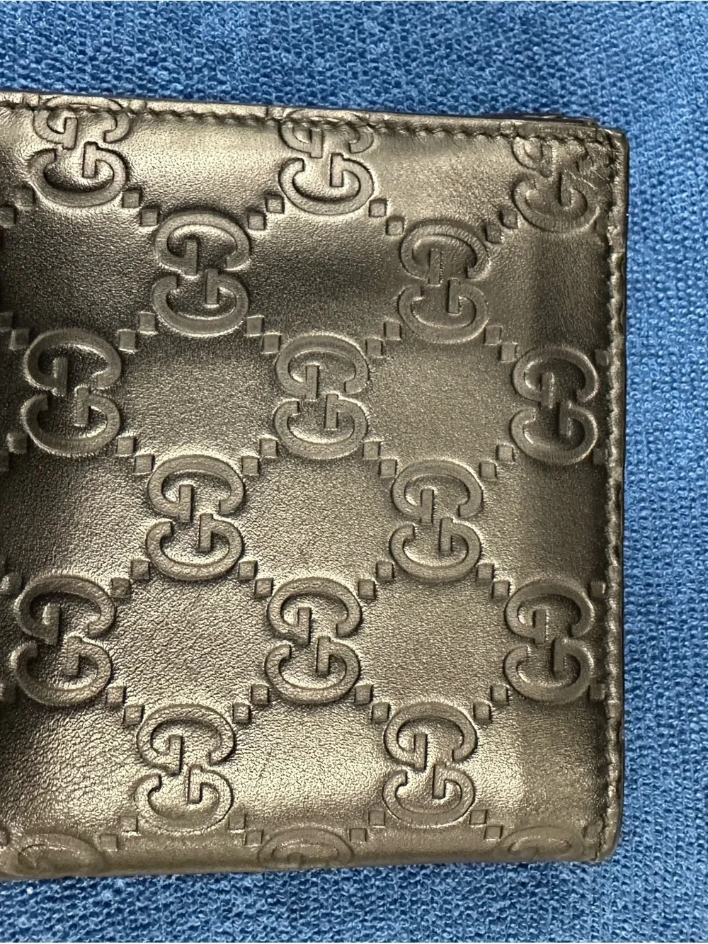 Gucci Black Embossed GG Leather Men's Bifold Wallet with Gold Accent